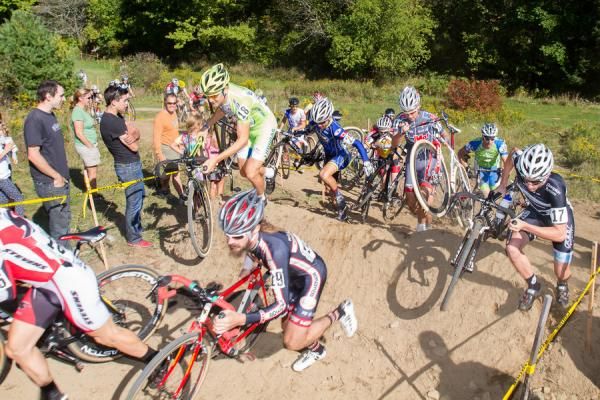 Ted King of Liquigas-Cannondale runs for it as the Elite Men hit the chaos-causing berm, forcing all but the race leaders off their bikes.