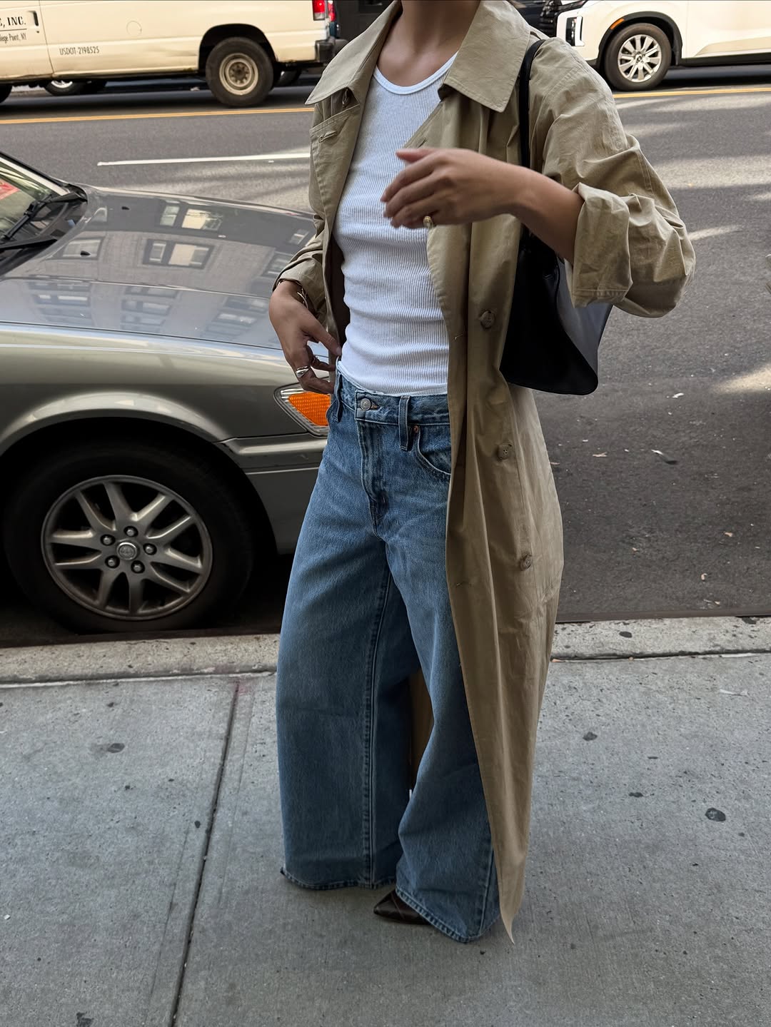 Woman wearing a tan jacket with jeans in a fall 2025 outfit.