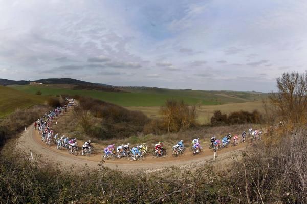 The peloton negotiates a section of unmade road.