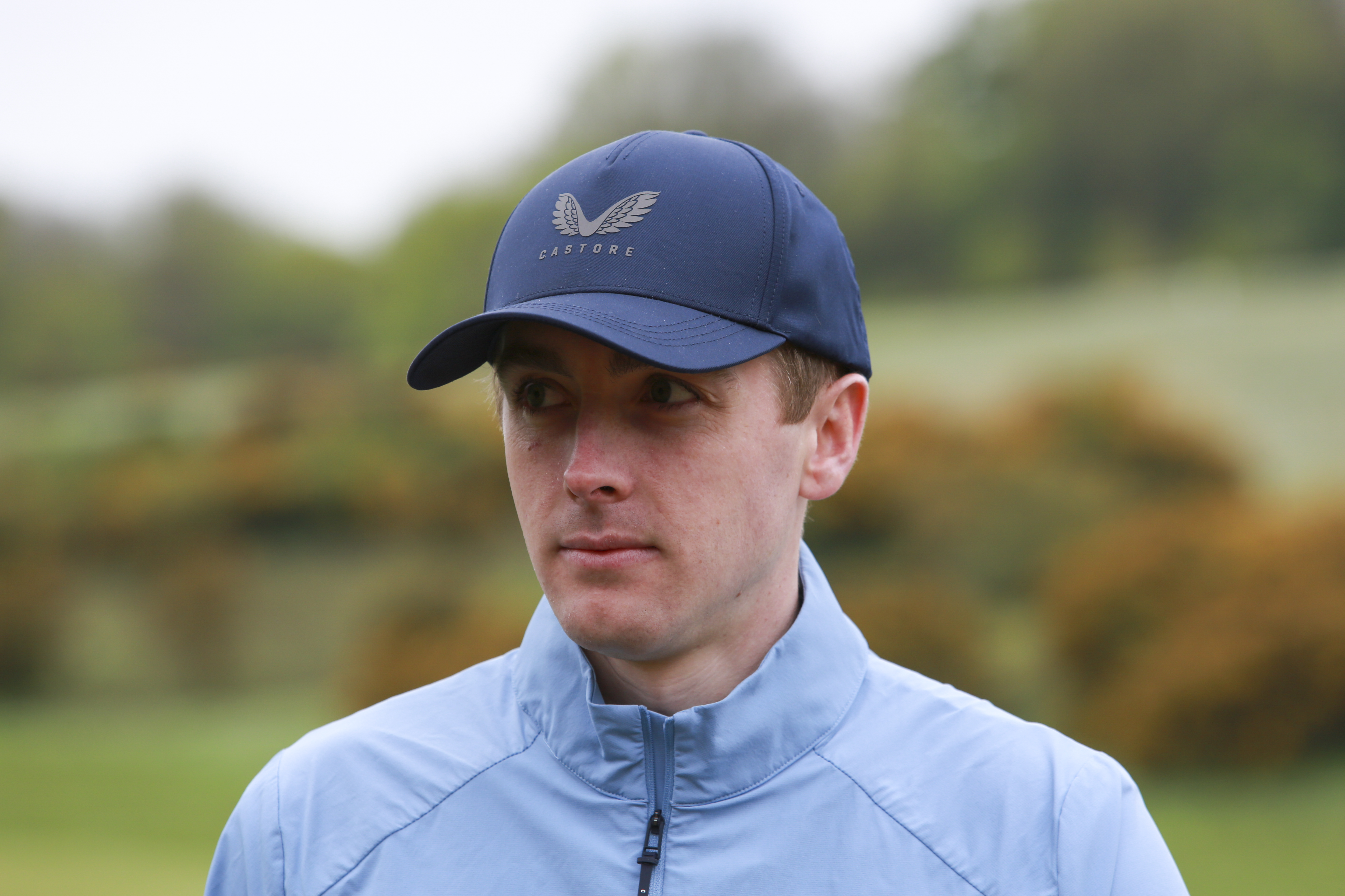 A headshot of Golf Monthly staff news writer, Jonny Leighfield in a navy blue Castore cap