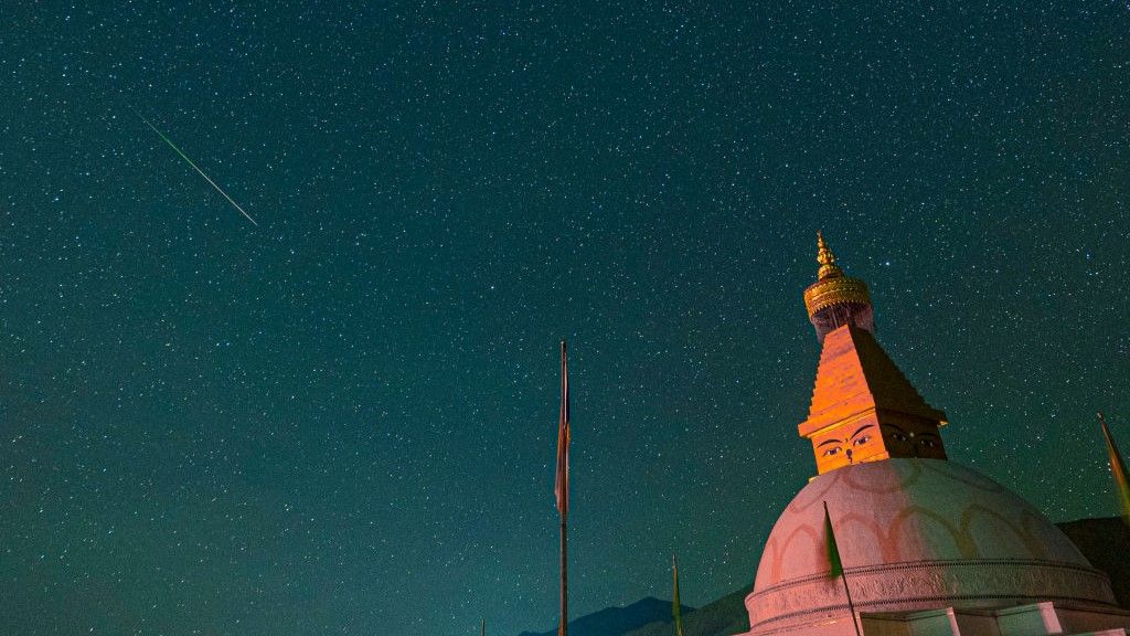 A meteor streaks across the sky during the Perseid meteor shower on August 13, 2023 in Golog Tibetan Autonomous Prefecture, Qinghai Province of China.