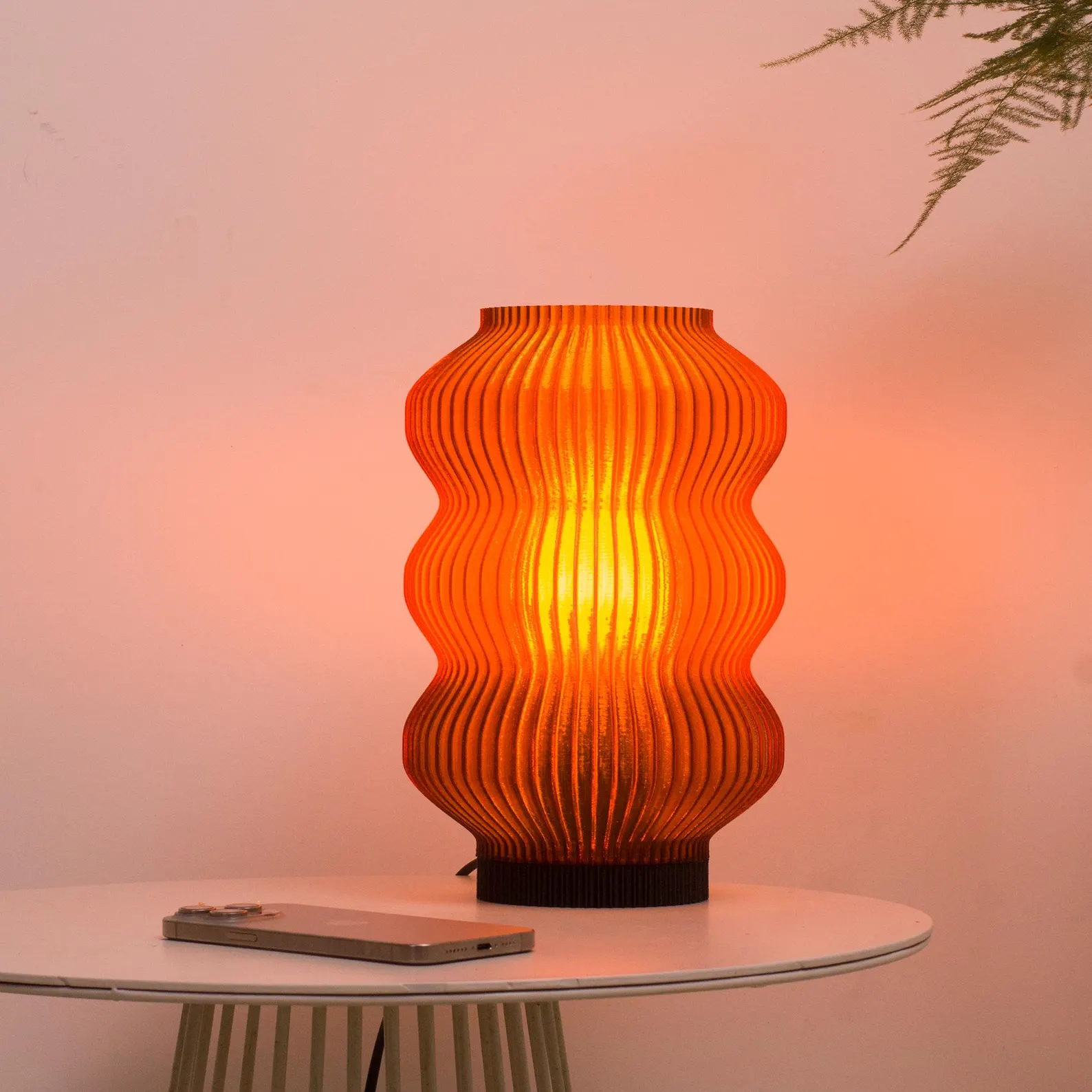 A curved table lamp giving off a soft amber glow