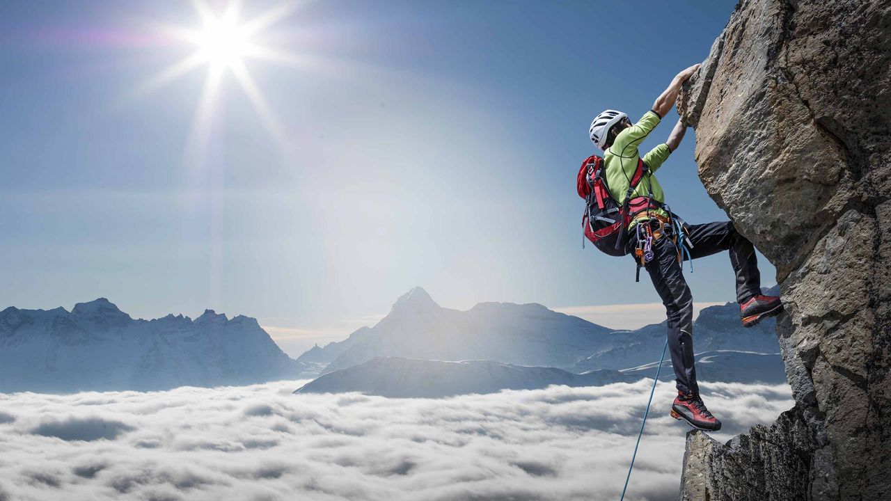 person climbing mountain