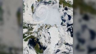 In an image taken from space, an Arctic cyclone is seen swirling over the Arctic Ocean on July 28, 2020. Arctic cyclones can cause rapid sea ice melt.