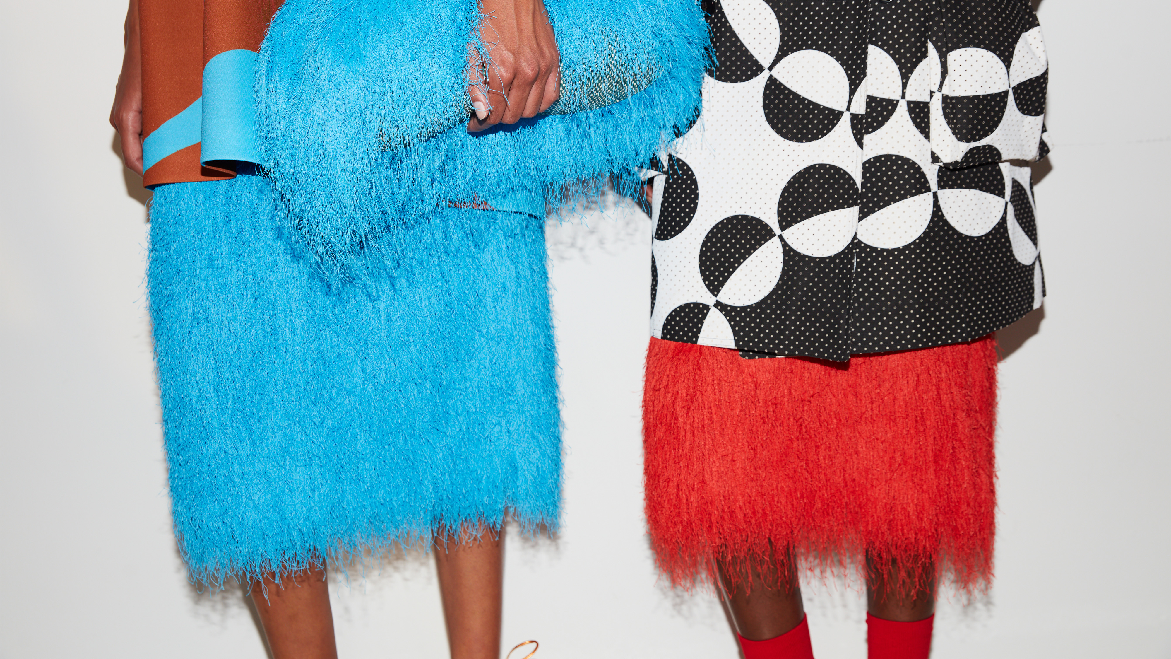 A photo of two models at the Dries Van Noten SS26 show.
