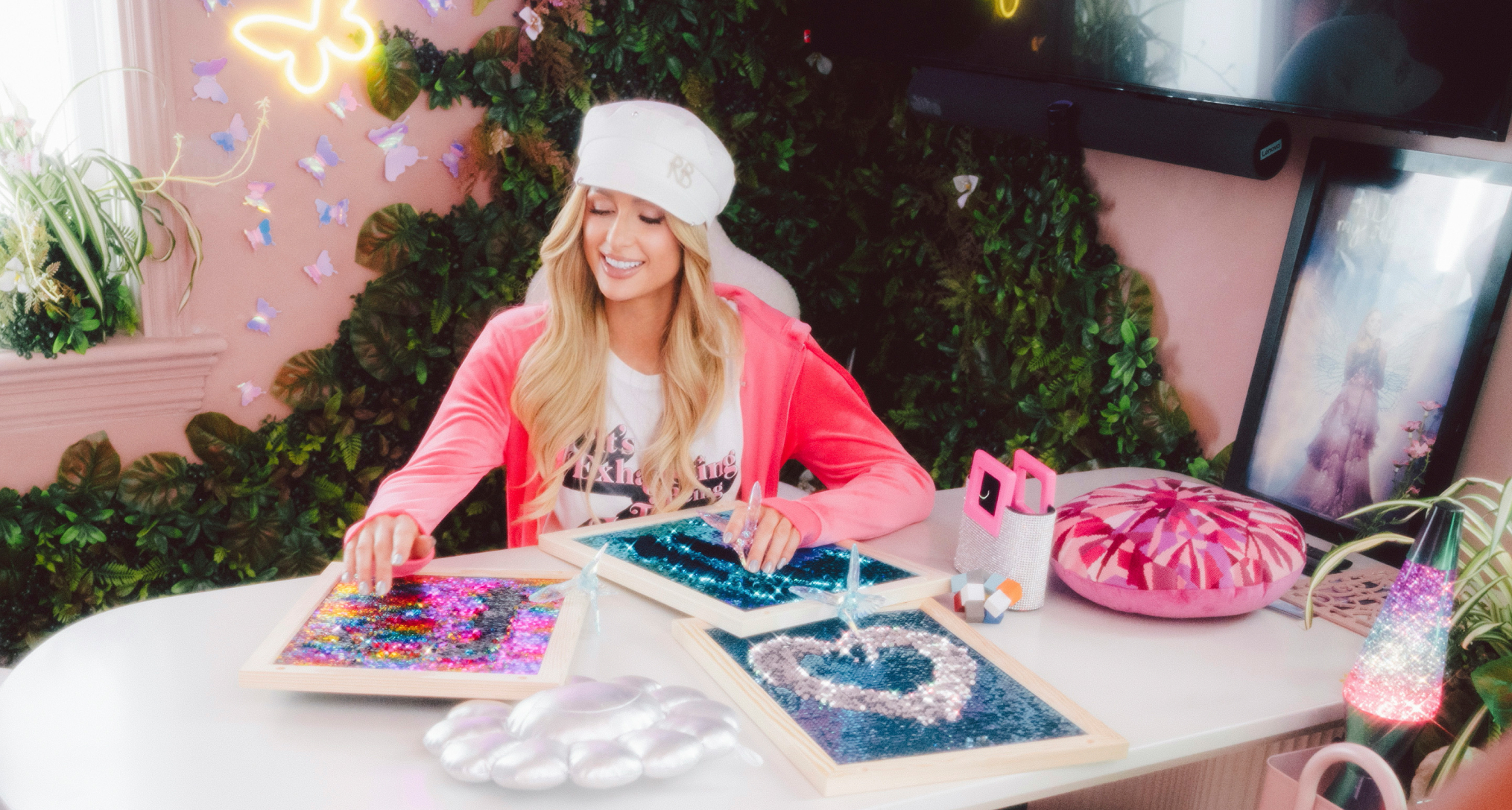Paris Hilton sitting at a table doing crafts