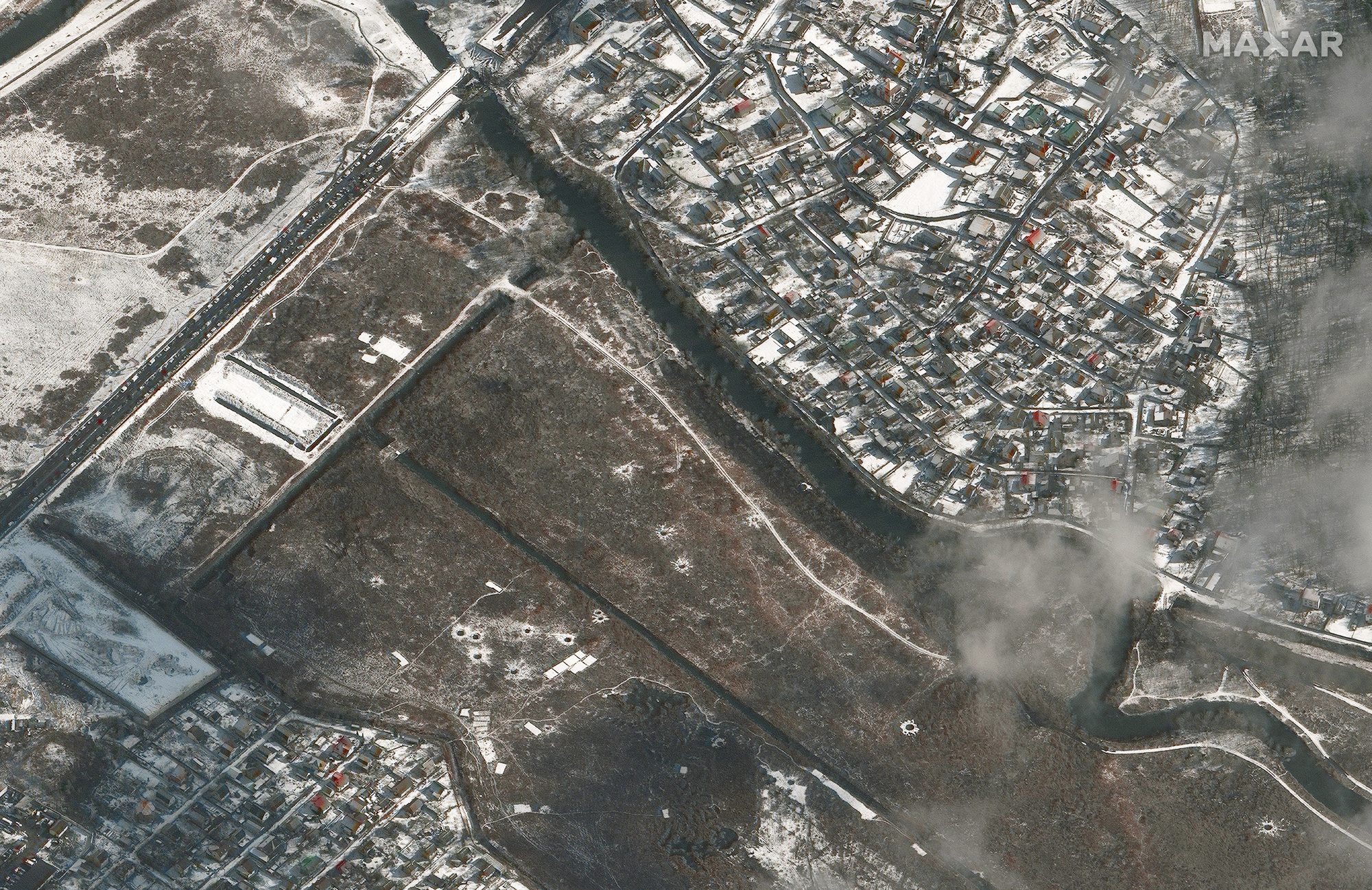 This satellite image shows a wide of the Irpin Bridge and craters in a surrounding field west of Kyiv, Ukraine on March 8, 2022 as seen by Maxar's WorldView 3 satellite.