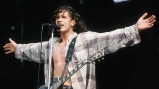 Chris Cornell on stage with his arms outstretched