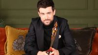 Brit Awards 2026 host Jack Whitehall clutching an award