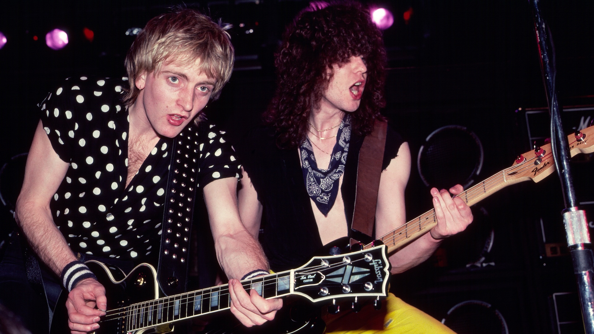 Phil Collen and Rick Savage perform onstage during the 'Pyromania' tour at Nassau Coliseum (later Nassau Veterans Coliseum), Uniondale, New York, March 25, 1983. 