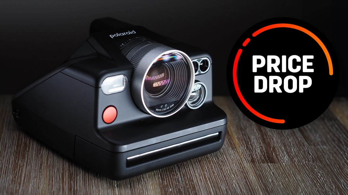 Polaroid I2 on a wooden surface with the text, in a black circle, reading &quot;price drop&quot;