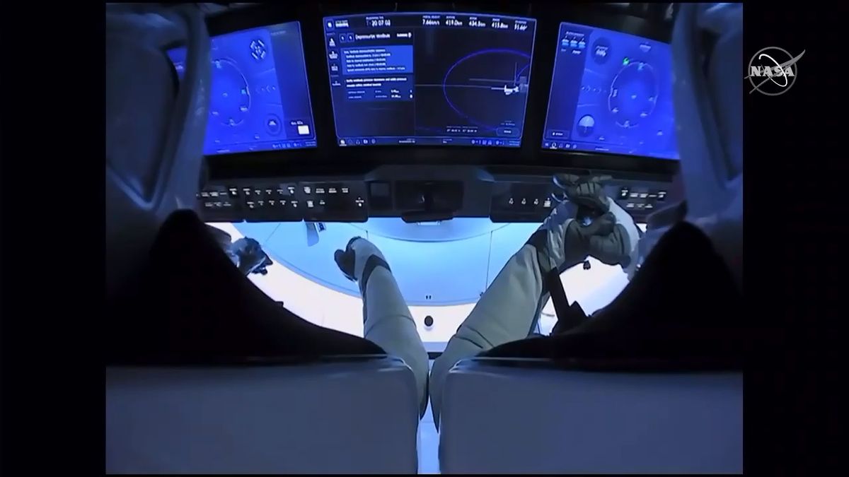 NASA astronauts Doug Hurley (left) and Bob Behnken sit inside their SpaceX Crew Dragon Demo-2 spacecraft before undocking from the International Space Station, on Aug. 1, 2020.