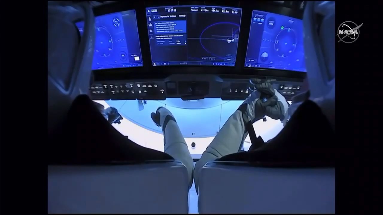 NASA astronauts Doug Hurley (left) and Bob Behnken sit inside their SpaceX Crew Dragon Demo-2 spacecraft before undocking from the International Space Station, on Aug. 1, 2020.