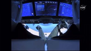 NASA astronauts Doug Hurley (left) and Bob Behnken sit inside their SpaceX Crew Dragon Demo-2 spacecraft before undocking from the International Space Station, on Aug. 1, 2020.