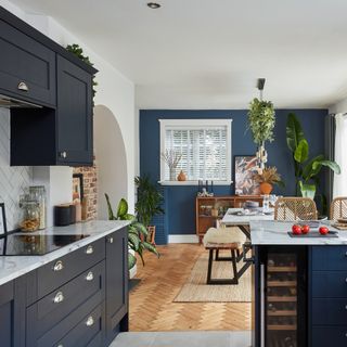 Navy shaker kitchen with herringbone flooring