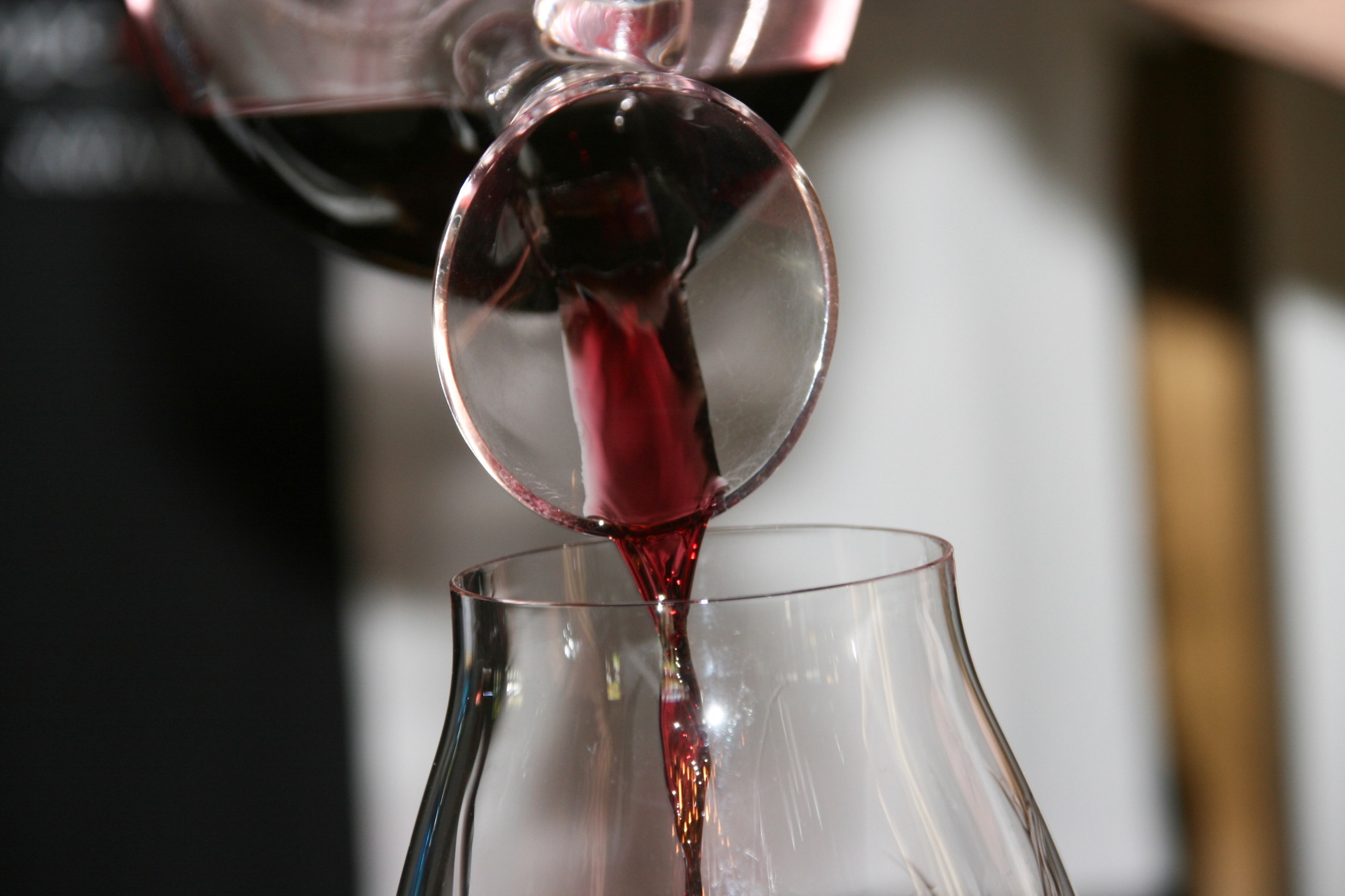 wine being poured from a decanter