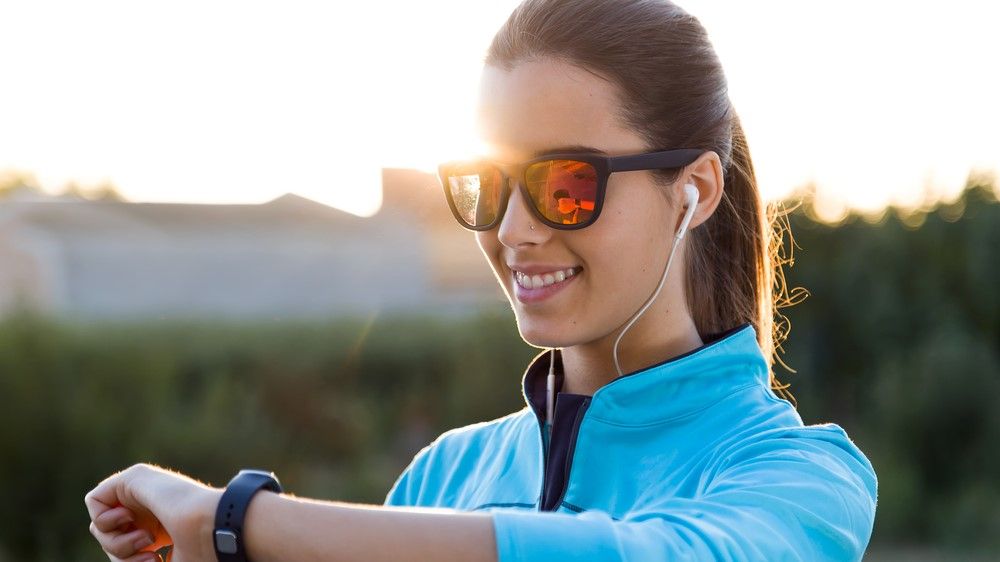 a photo of a female runner wearing sunglasses