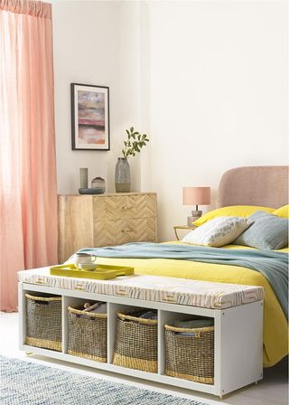 bedroom with peach curtains and wooden vanity