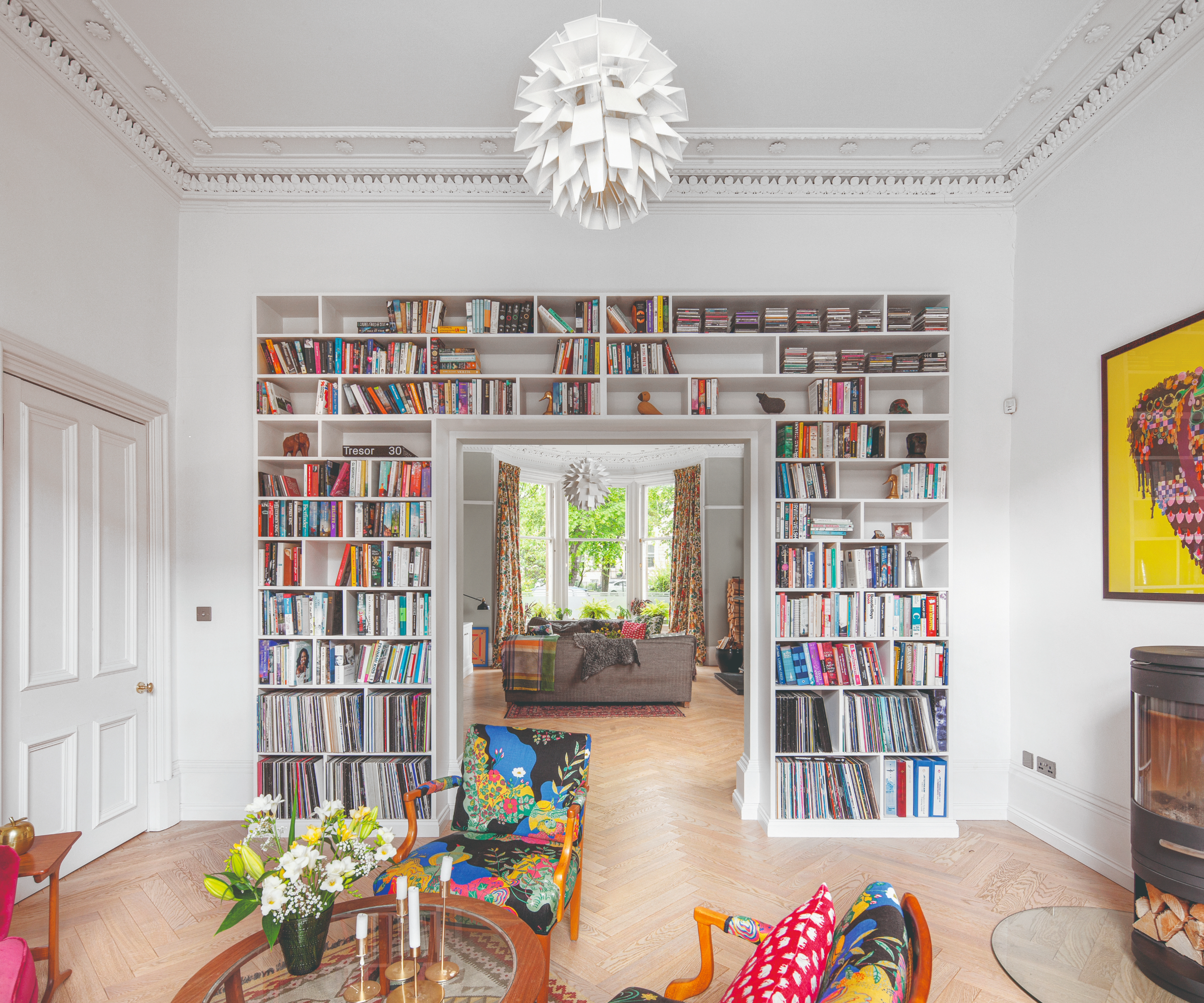 Built in storage idea where a bookshelf wraps around a door frame