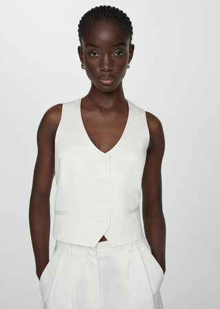 model wears white linen vest and matching shorts