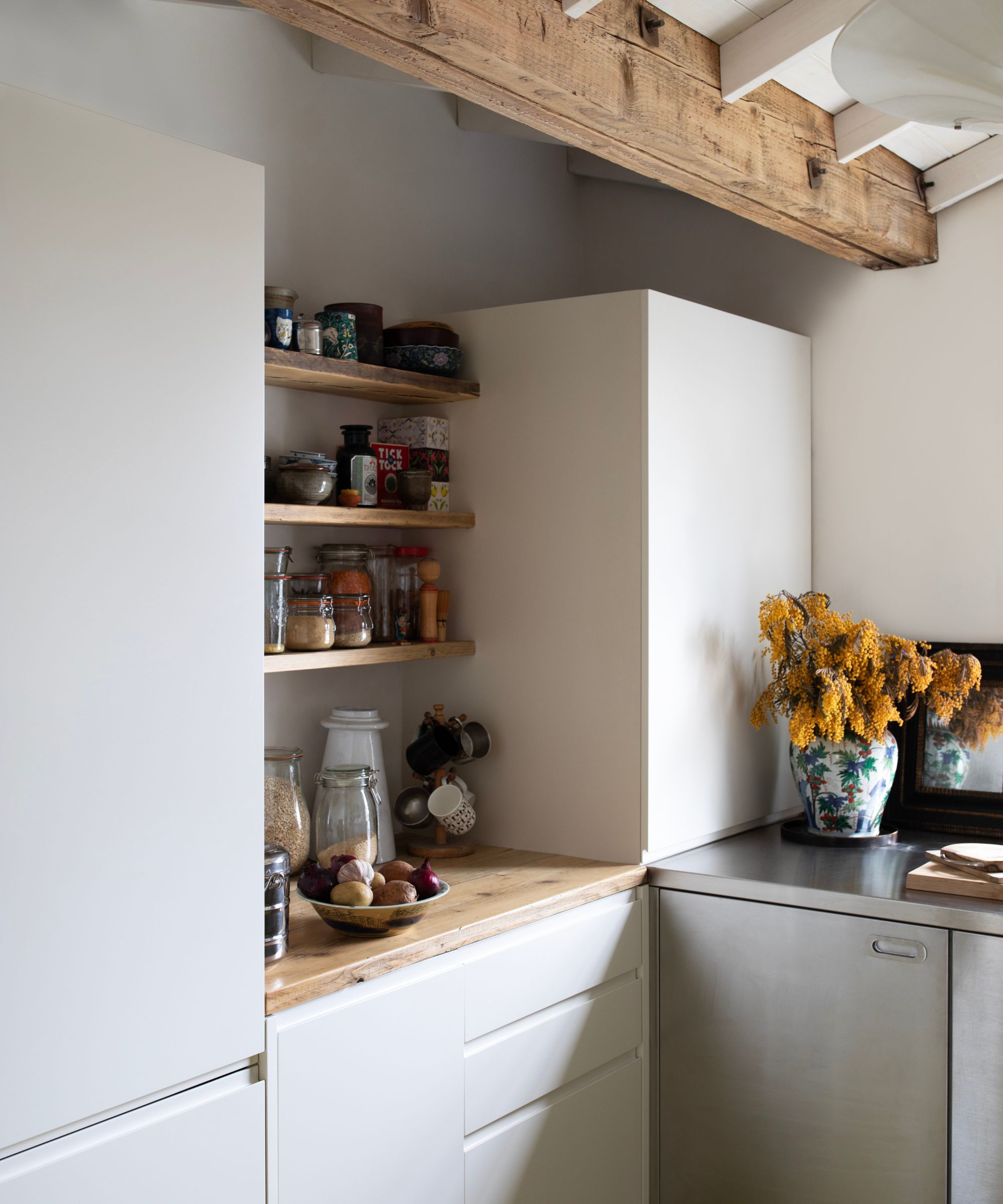 kitchen with stainless steel cabinets, a green floor, and white walls covered in art stainless steel and white kitchen with wooden countertops and open shelving