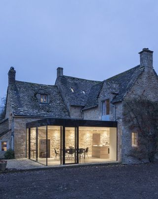Glass box extension to period house with black framed glazing