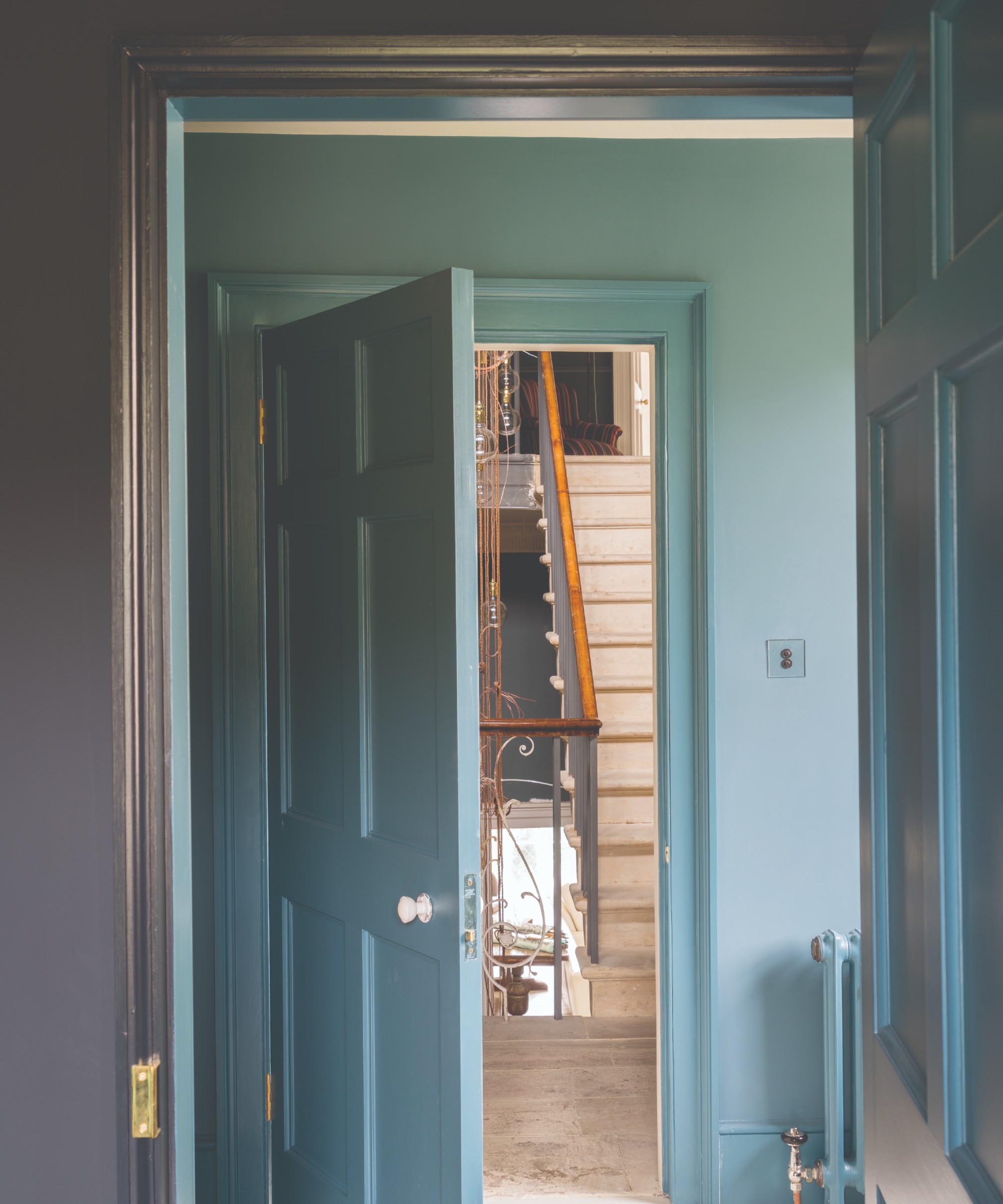 A blue hallway painted in Farrow &amp;amp; Ball&#039;s Inchyra Blue