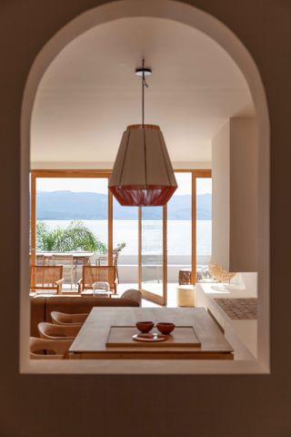 Room with sea side view and ceiling lamp