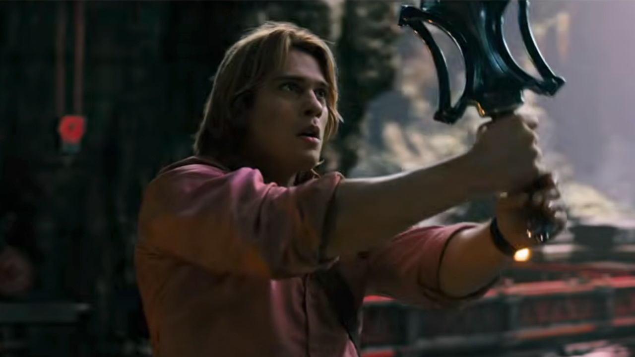 Nicholas Galitzine holding the sword of power in Masters of the Universe