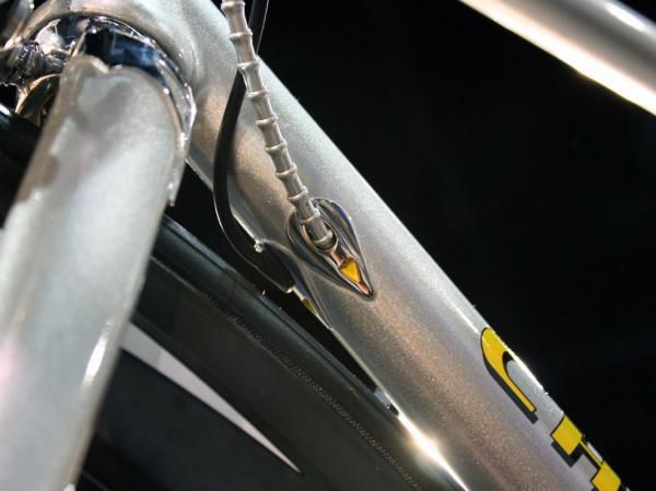 Ornate entry ports for the Di2 wire and rear brake cable are brazed to the underside of the down tube.