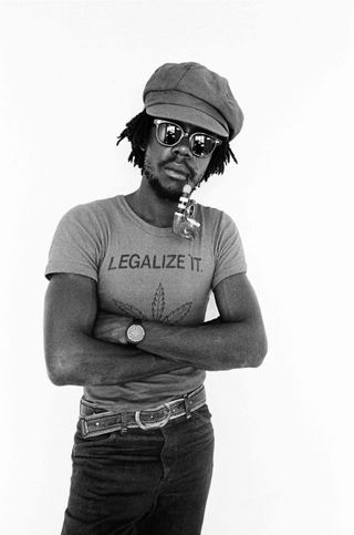 a portrait of Peter tosh against a white background