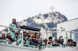 Surviving migrants wait to disembark the Spanish ship that rescued them from the Mediterranean Sea, 2017.