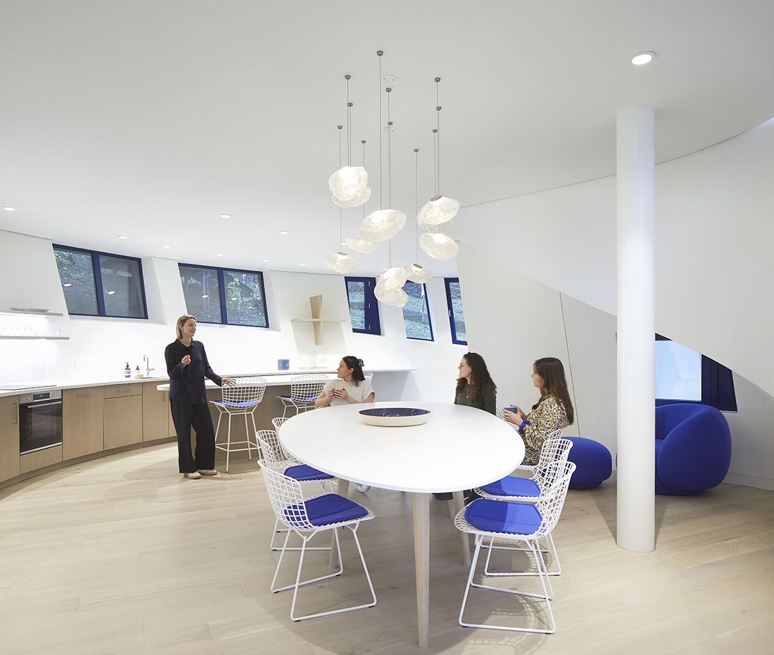 kitchen area in Maggie's Royal Free with people sat around table