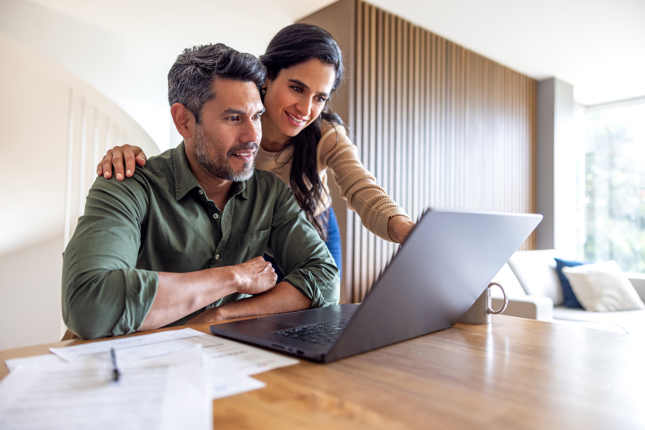 a couple making financial decisions in their home office