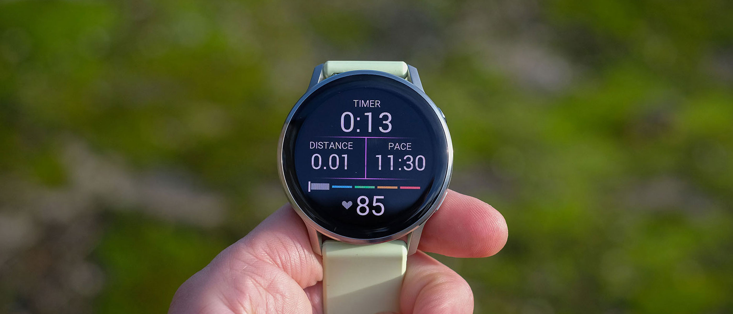 a close-up picture of our reviewer holding the Garmin Venu 4 smartwatch displaying real-time workout stats