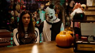 Lauren LaVera being terrorised by David Howard Thornton in a Halloween shop in Terrifier 2.
