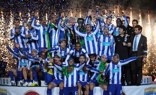 Porto celebrate with the trophy after winning the 2010/11 Portuguese league title