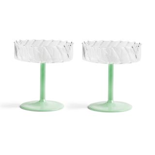 Two coupe glasses with green stems