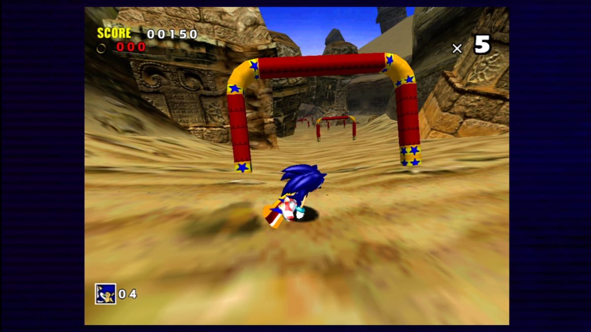 Sonic Adventure on the Dreamcast shows a 3D Sonic surfing down a sandy incline during the Sand Hill racing mode