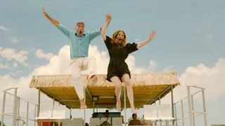 Julia Roberts and George Clooney jump off a boat together in Ticket to Paradise