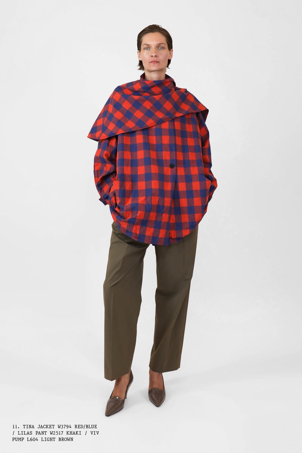 A photo from The Row's Spring 2025 collection including a blue-and-red plaid shirt and green pants.