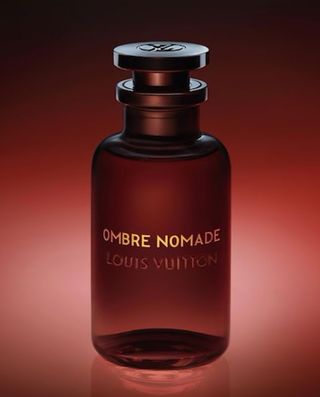 Bottle of Ombre Nomad perfume against a dark red and black background