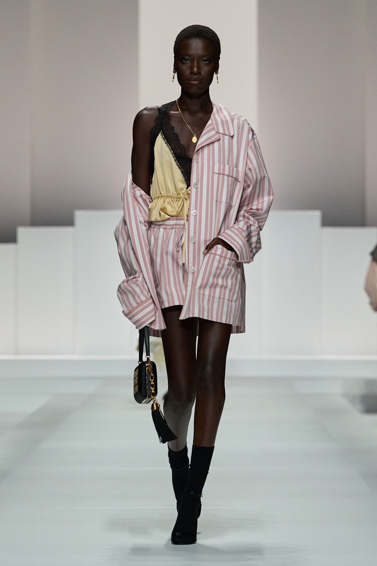 Women on dolce & Gabbana runway show wearing pajama-inspired outfits.
