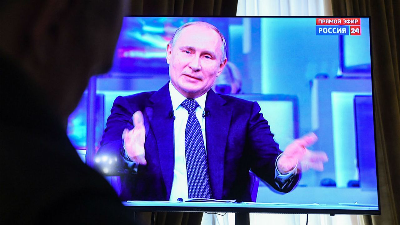 Journalists watch a live broadcast of Vladimir Putin&amp;#039;s annual televised phone-in with the nation