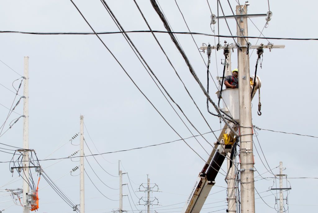 A person works on restoring power in Puerto Rico.