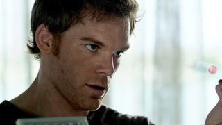 Michael C Hall holds up a blood sample and stares at it in Dexter