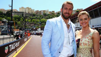 MONTE-CARLO, MONACO - MAY 24:England captain Chris Robshaw outshone by girlfriend Camilla Kerslake are seen outside the Infiniti Red Bull Racing team garage before the Monaco Formula One Gran