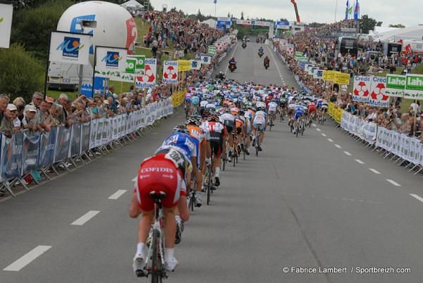The peloton passes through the finish line