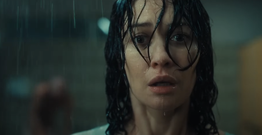 Olga Kurylenko standing in the rain in O.T.H.E.R