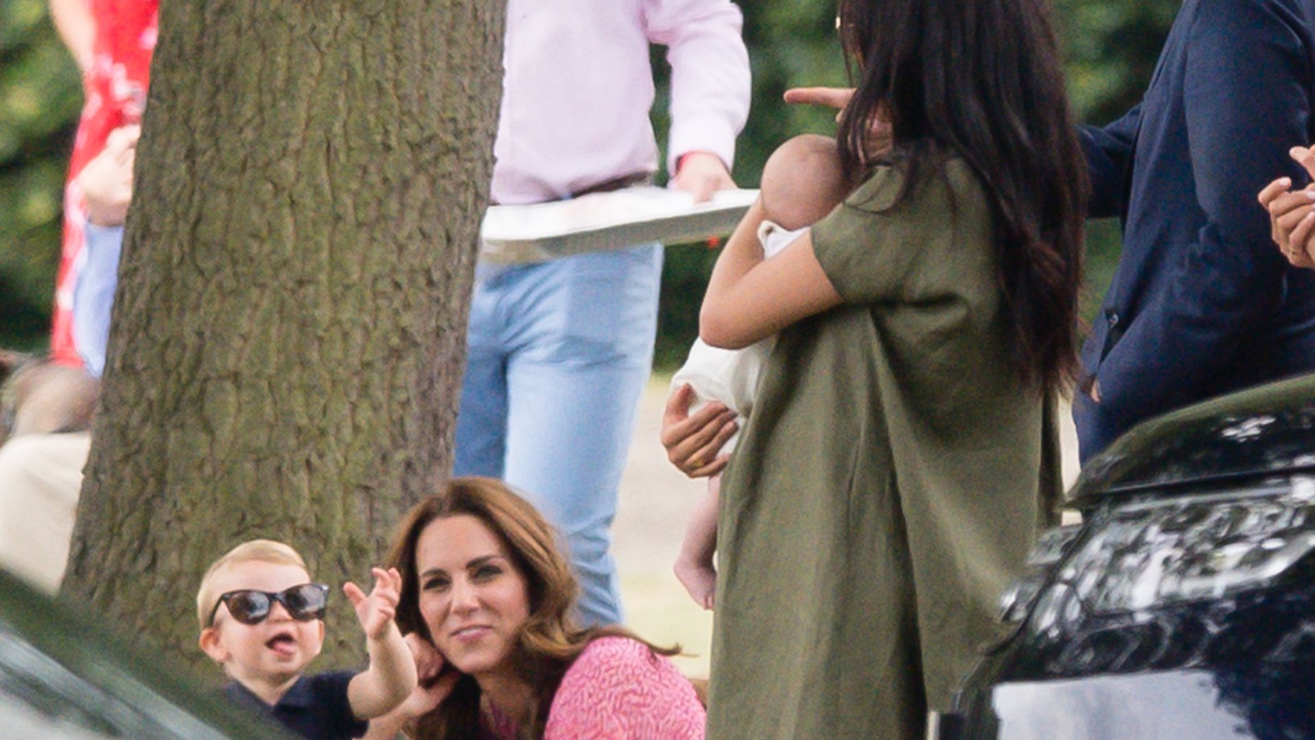 Meghan, Duchess of Sussex holds baby Prince Archie whilst Catherine, Princess of Wales and Prince Louis look on, as they attend The King Power Royal Charity Polo Day on July 10, 2019